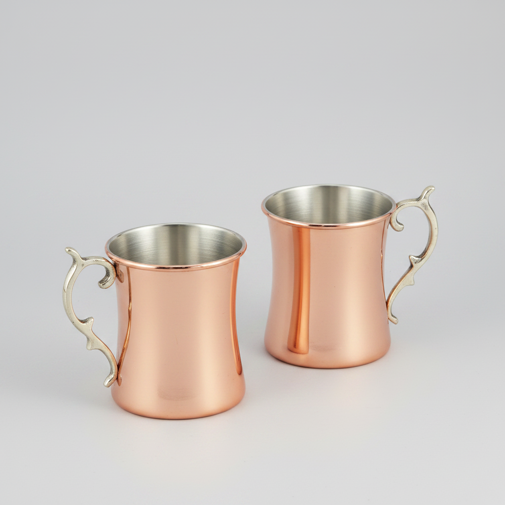 Two copper mugs with handles on a white background