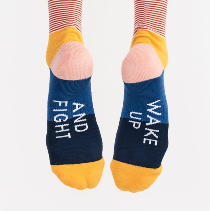 Colorful socks with motivational text on a white background