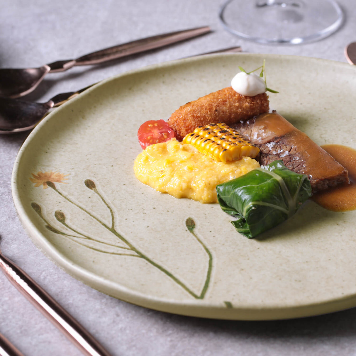Plated dish with various foods on a decorative plate