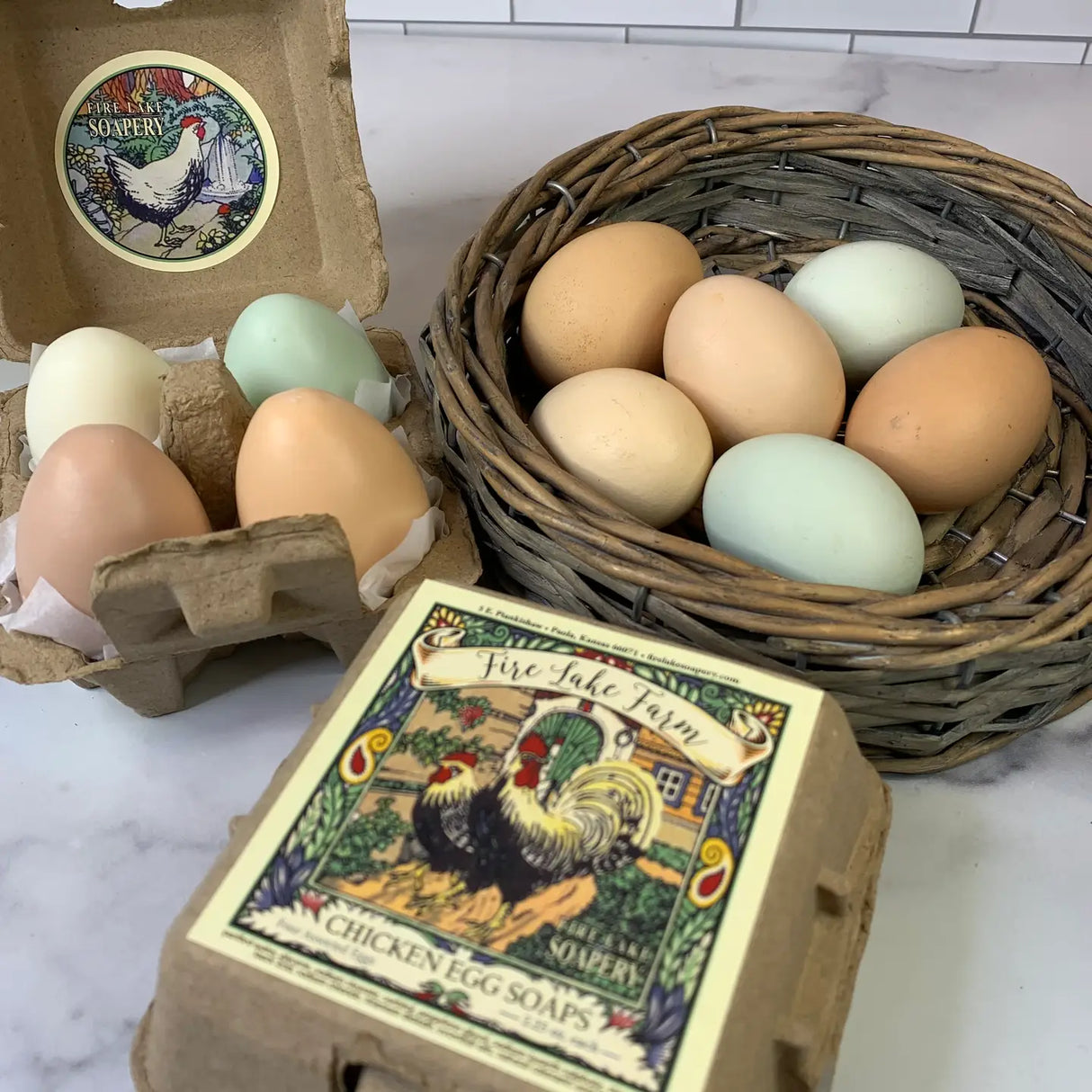 Eggs in a carton and basket with a box of chicken egg soaps on a marble surface.