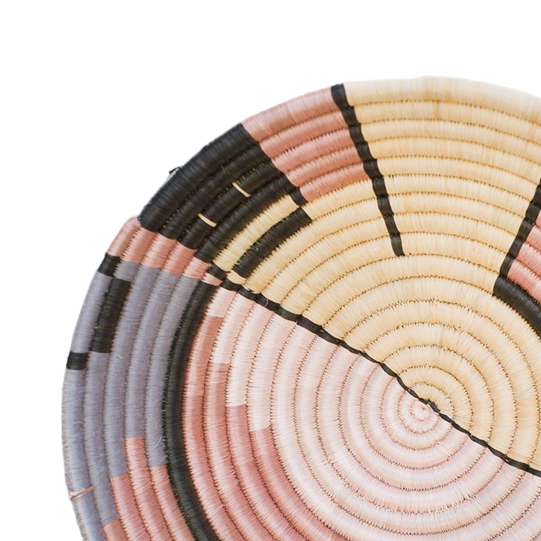 Woven basket with concentric circular pattern on a light background