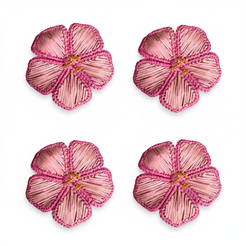 Four pink flower-shaped napkin rings on a white background