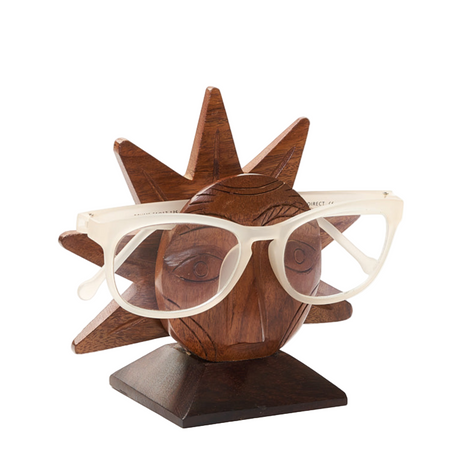 Wooden sun-shaped eyeglass holder with glasses on a white background