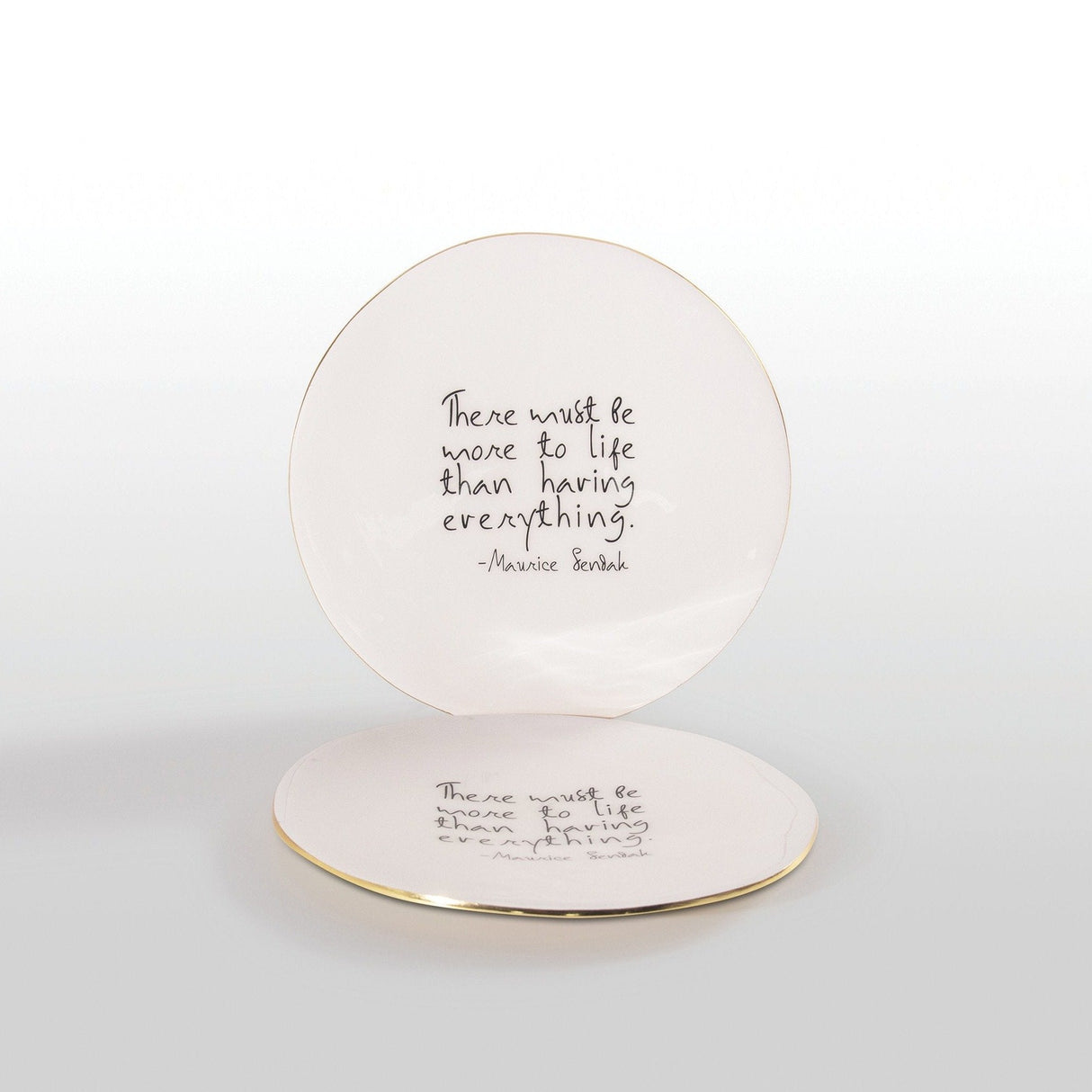 Round ceramic plate with a quote by Maurice Sendak on a white background