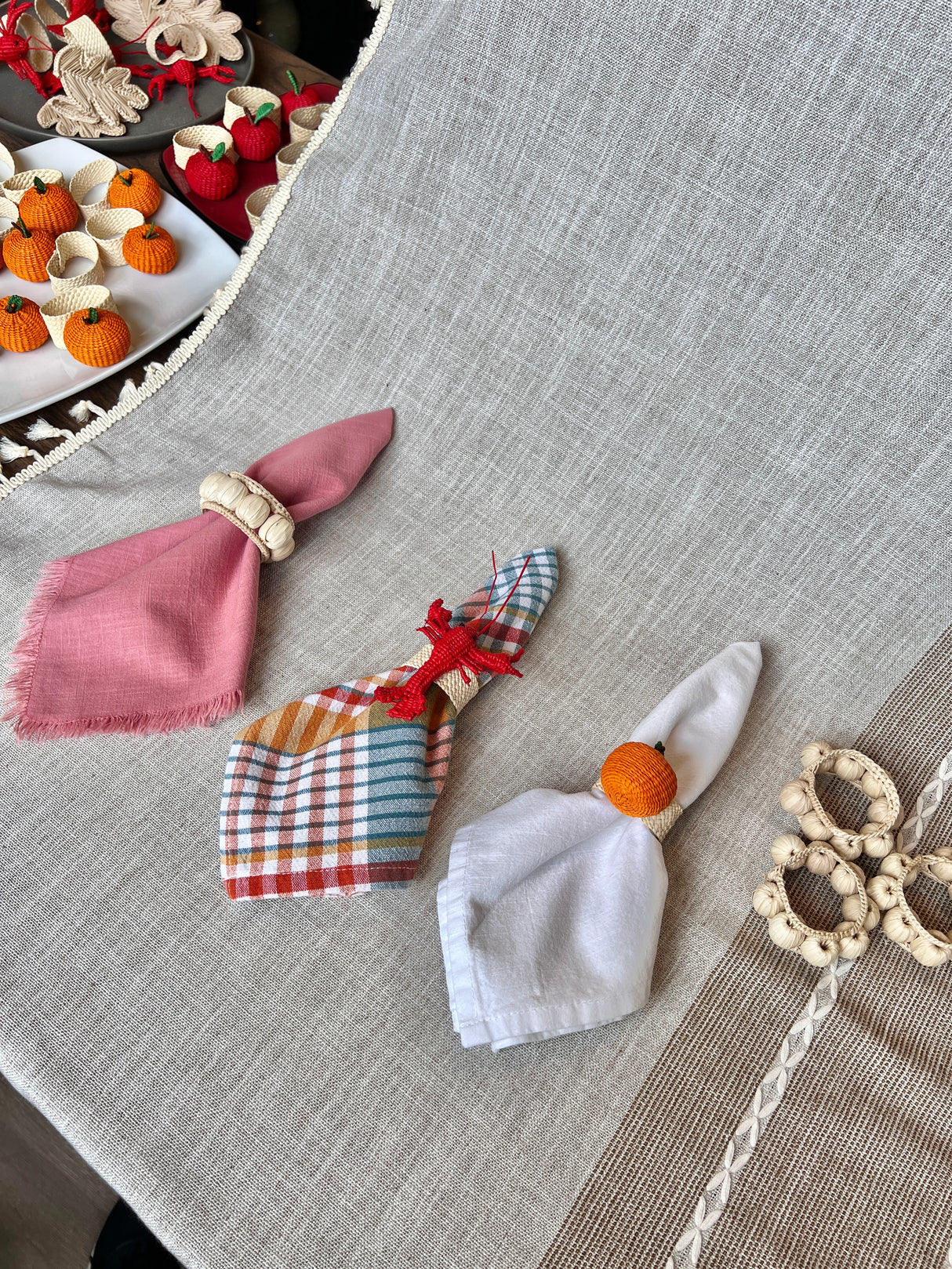Decorative napkin rings on a textured surface with a blurred background