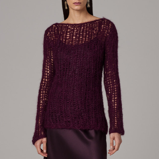 Maroon knitted sweater worn by a model on a gray background