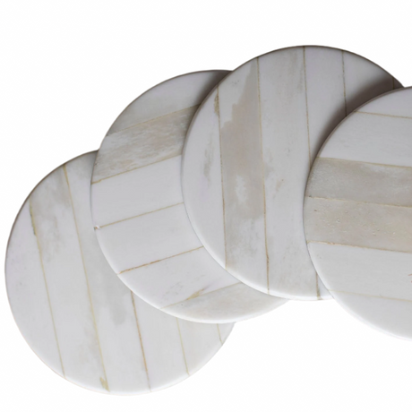 Set of four marble-patterned coasters on a white background