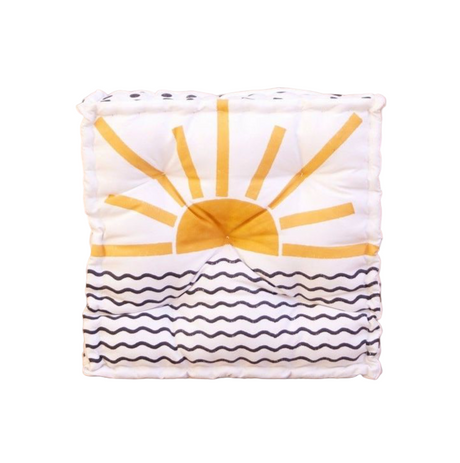 Pillow with sun design on a beige background
