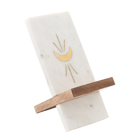 Marble phone holder with gold moon design 0n a white background