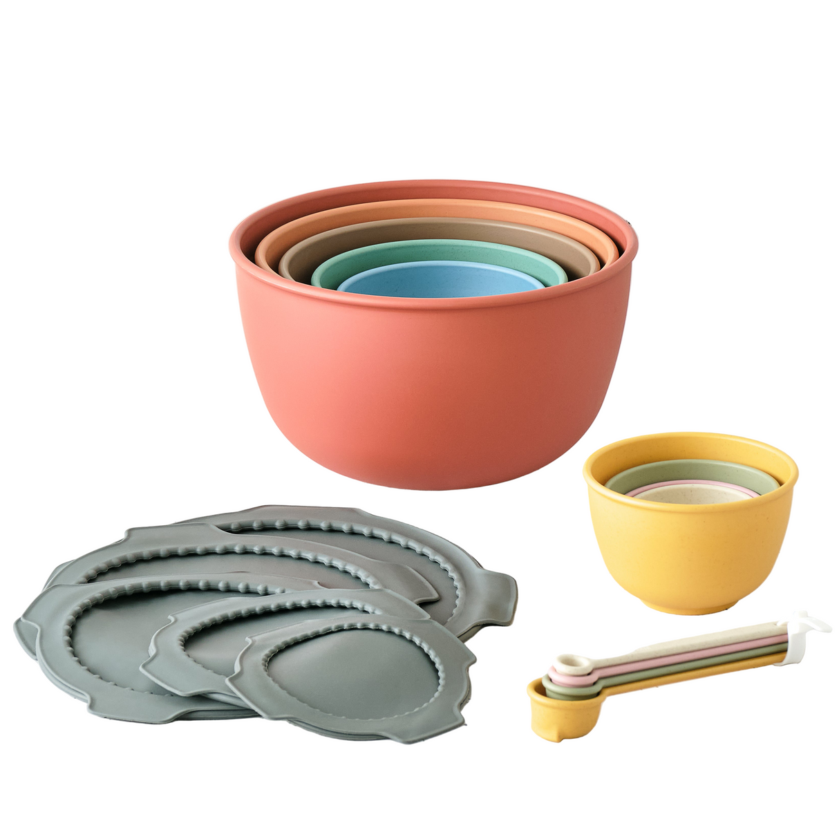 Set of colorful mixing bowls and lids on a light surface