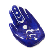 Blue ceramic hand-shaped dish with white designs on a white background