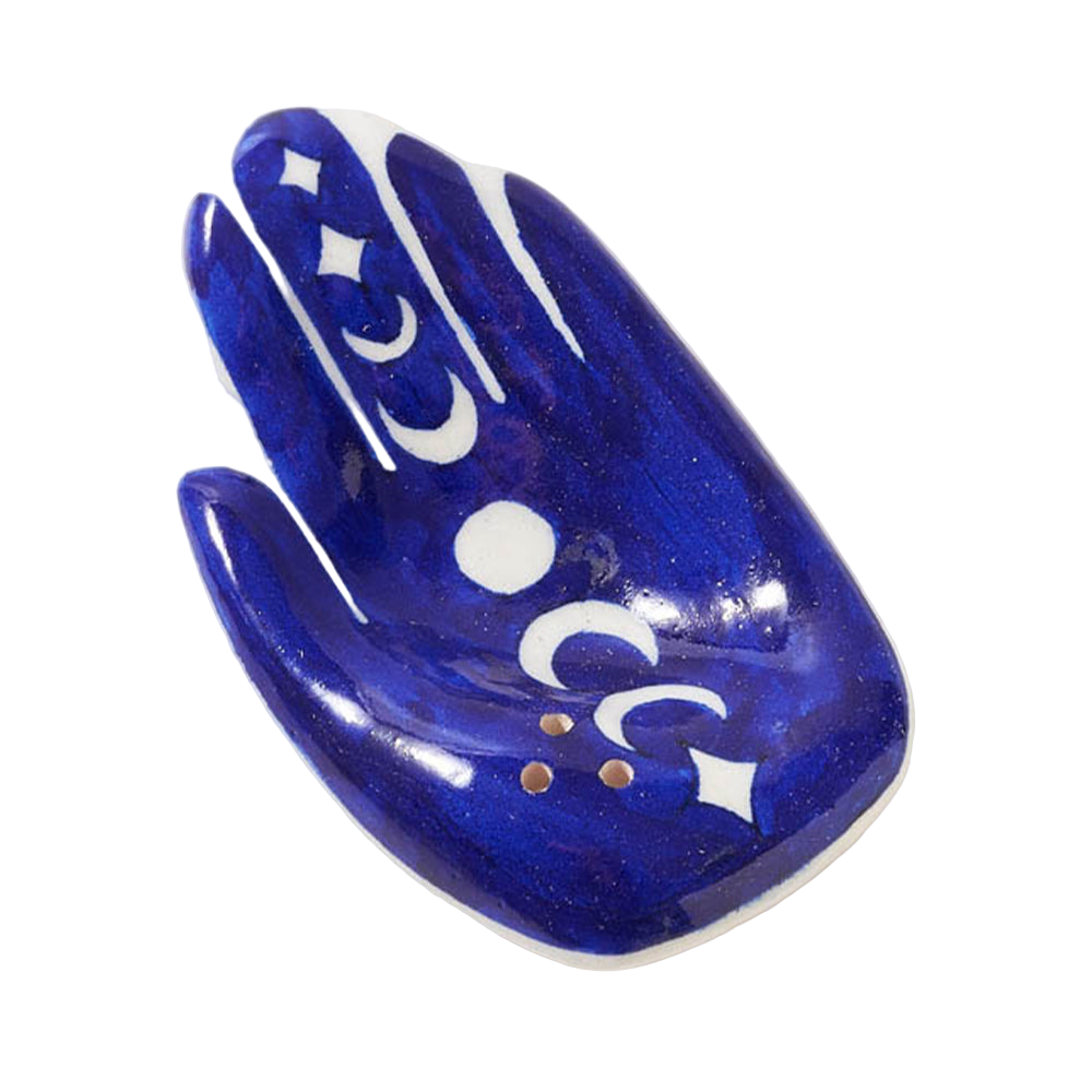 Blue ceramic hand-shaped dish with white designs on a white background