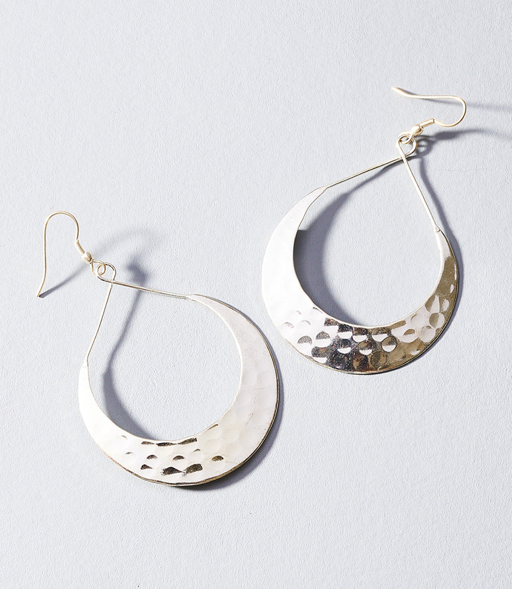 Pair of silver hoop earrings on a light gray background