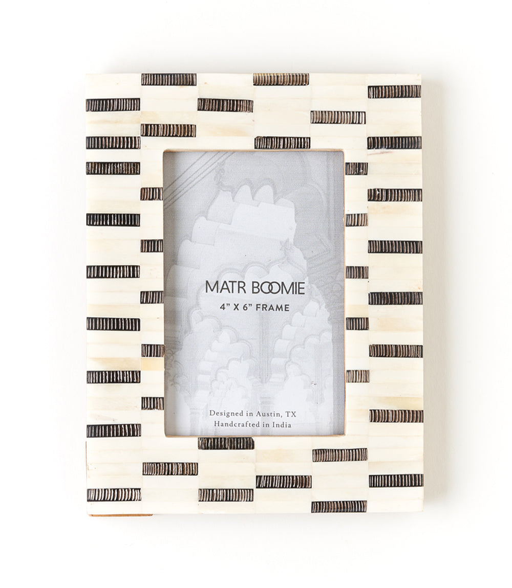 Black and white striped photo frame with 'MATR BOOMIE' branding on a white background