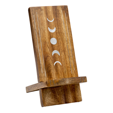 Wooden phone stand with moon phase design on a white background