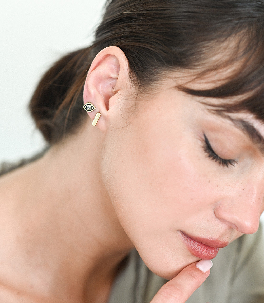 Close-up of a woman wearing earrings with a blurred background