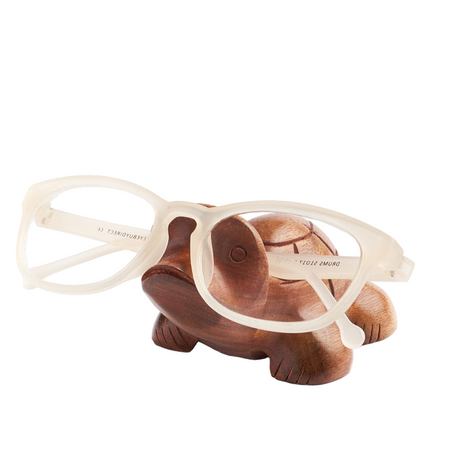 Wooden turtle-shaped eyeglass stand with glasses on a white background