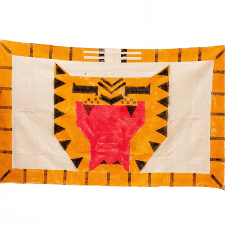 Decorative quilt with geometric pattern on a textured wall