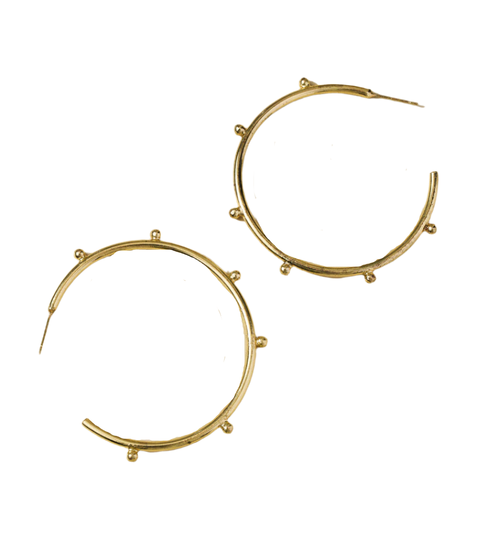 Pair of gold hoop earrings with beige stones on a white background