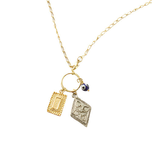 Gold necklace with two charms on a white background