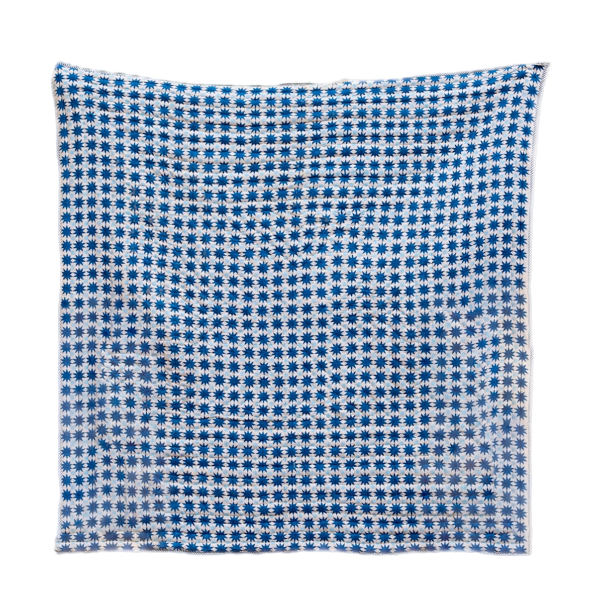 Blue and white checkered quilt on a white background