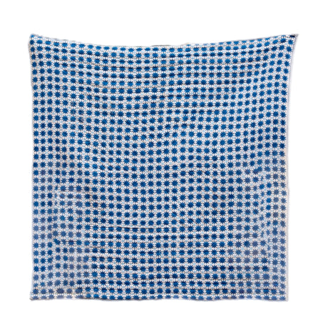 Blue and white checkered quilt on a white background