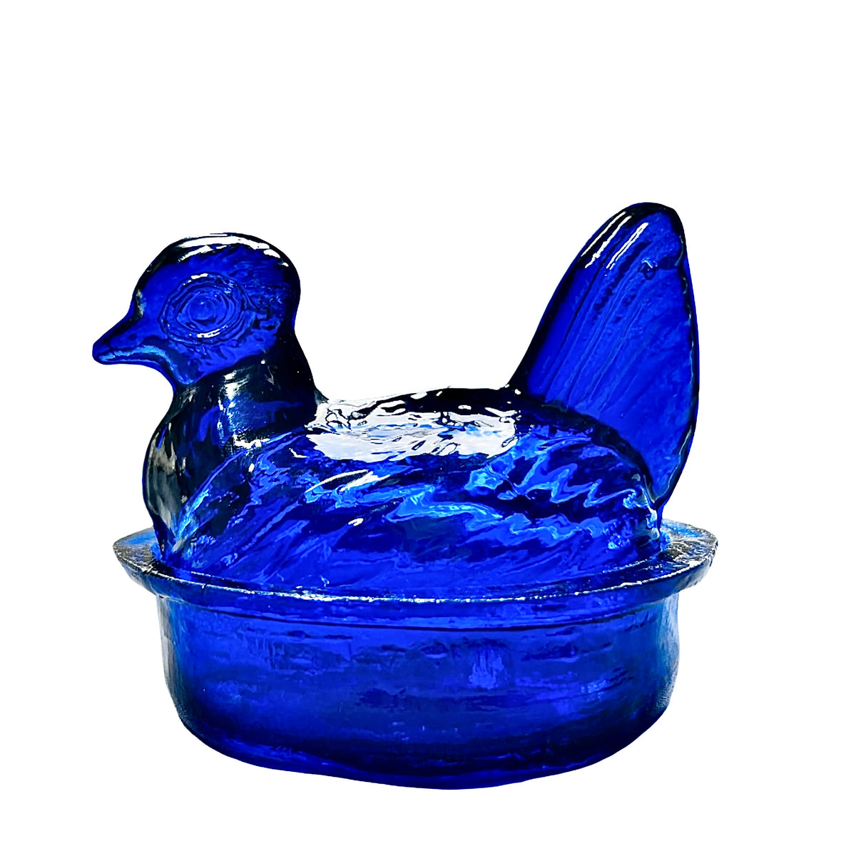 A hand blown glass nesting hen bowl and lid in sapphire blue color.