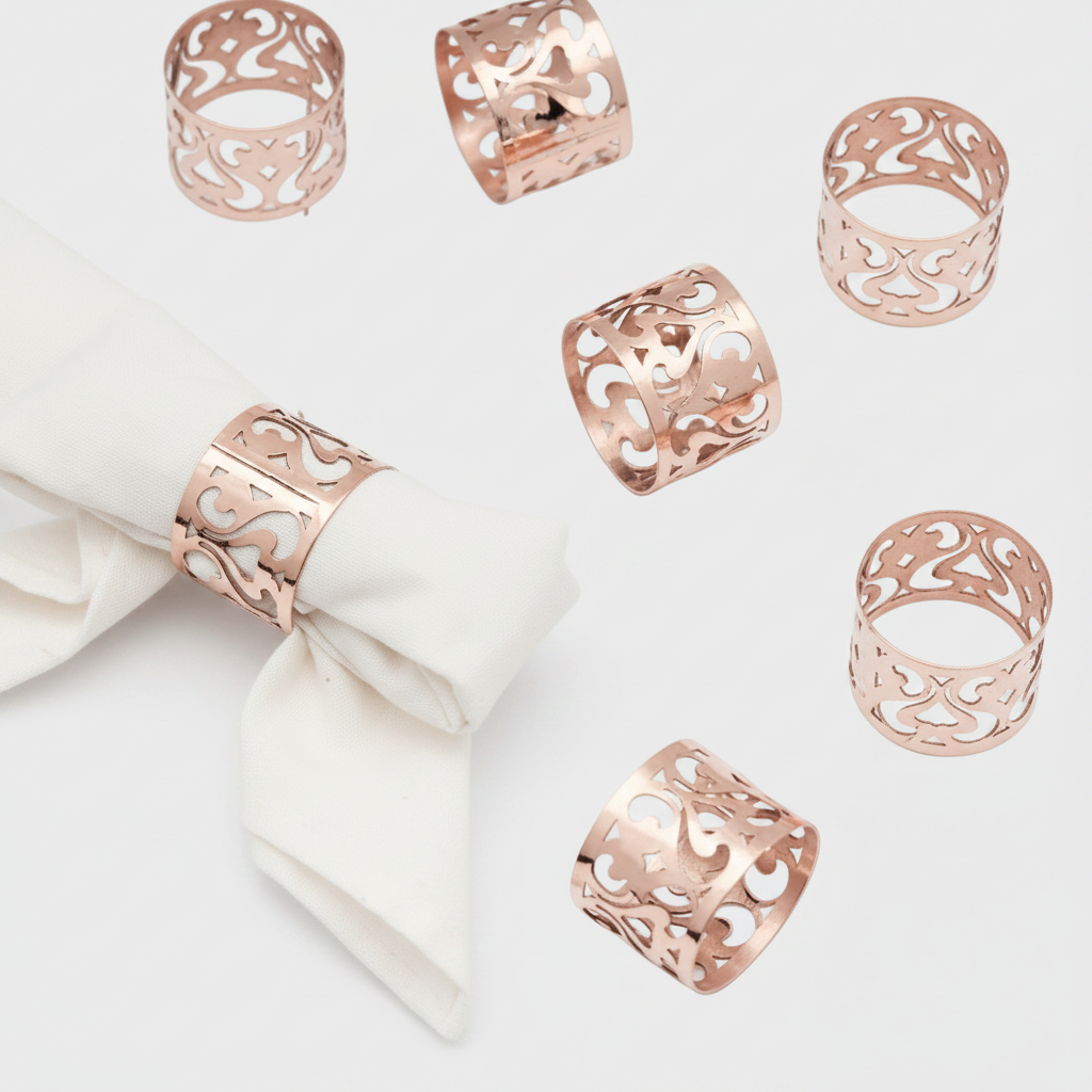 Set of copper napkin rings on a white napkin against a white background