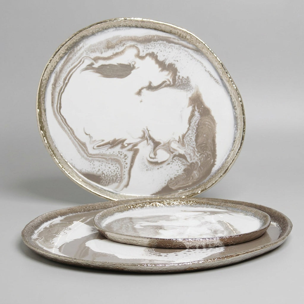 Set of ceramic plates with a marble-like design on a marble surface