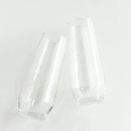 Two clear glass tumblers on a white background