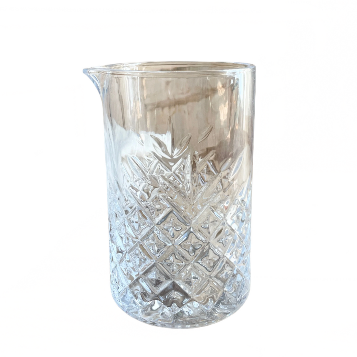 Clear glass pitcher with diamond pattern on a white background
