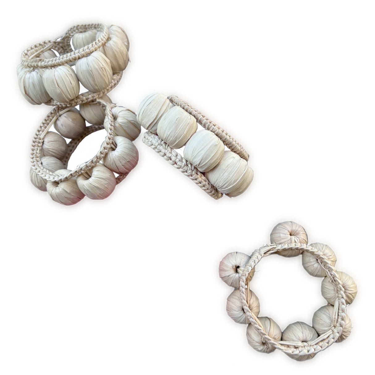 Set of decorative napkin rings with braided designs on a white background