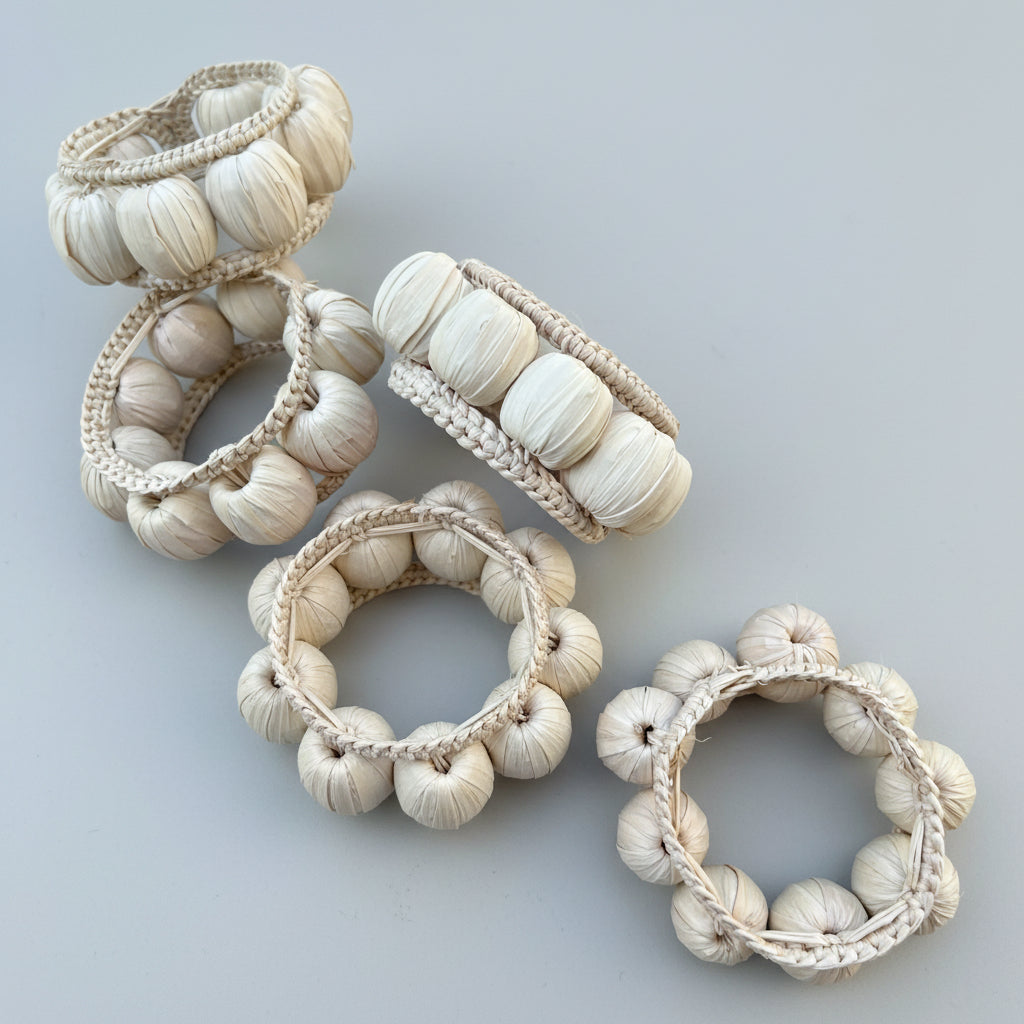 Set of decorative napkin rings with braided designs on a white background