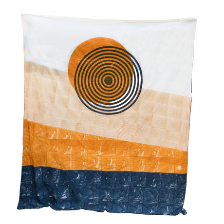 Duvet with a sunburst pattern and color block design against a desert-themed background.