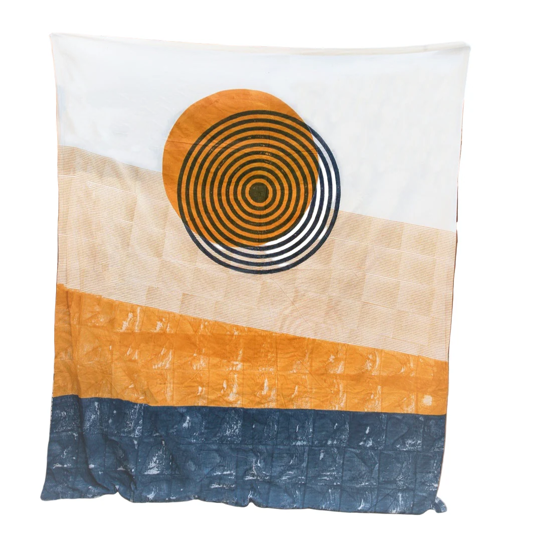 Duvet with a sunburst pattern and color block design against a desert-themed background.