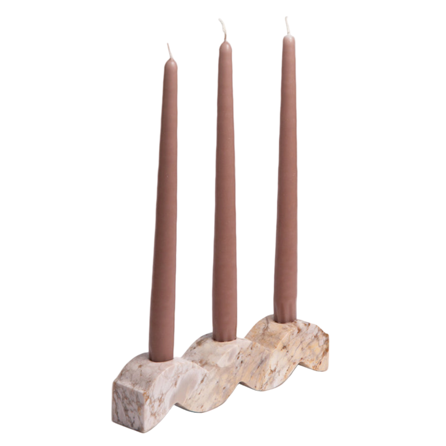 Decorative candle holder with three brown candles on a white background