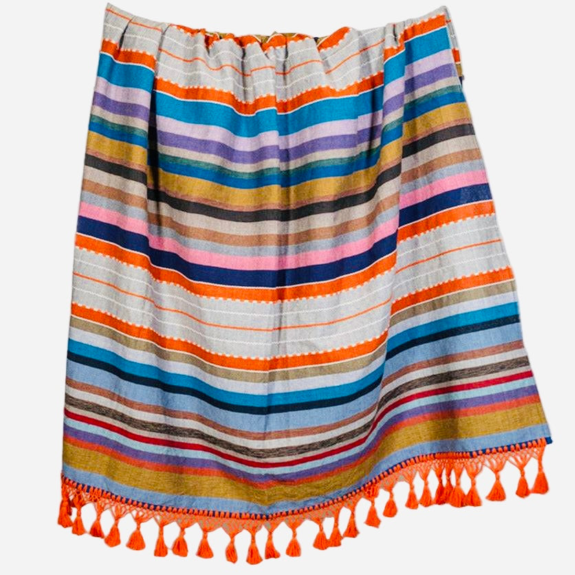 Colorful striped skirt with tassels on a white background