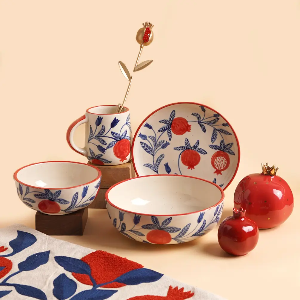 Ceramic tableware set with red, blue, and white floral patterns on a beige background
