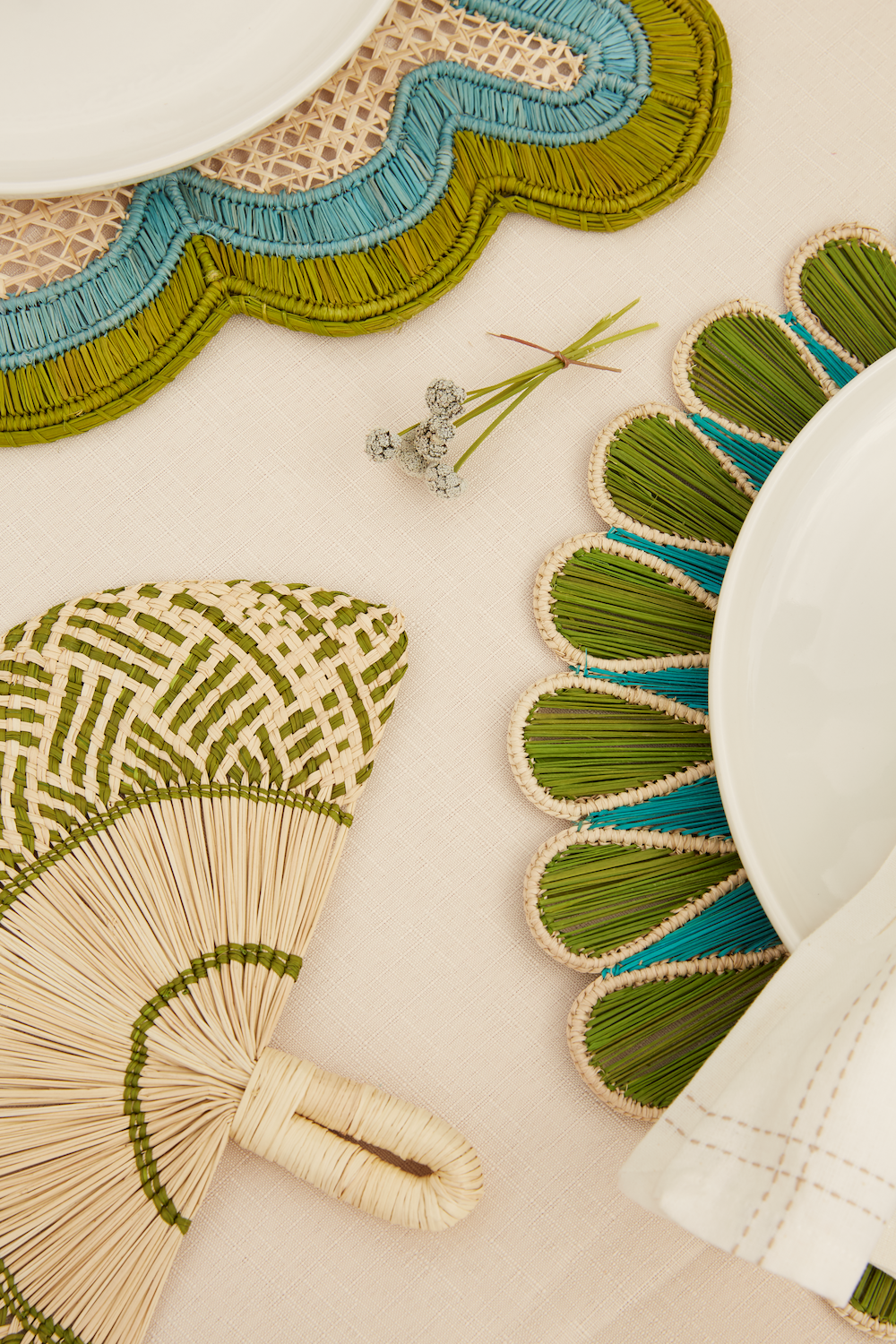 Decorative fans with green and blue patterns on a light background