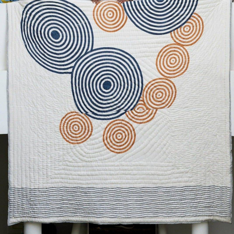 Quilt with circular pattern on a white background