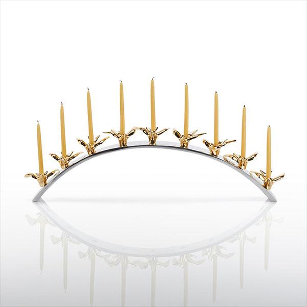 Decorative candle holder with gold birds and candles on a white background