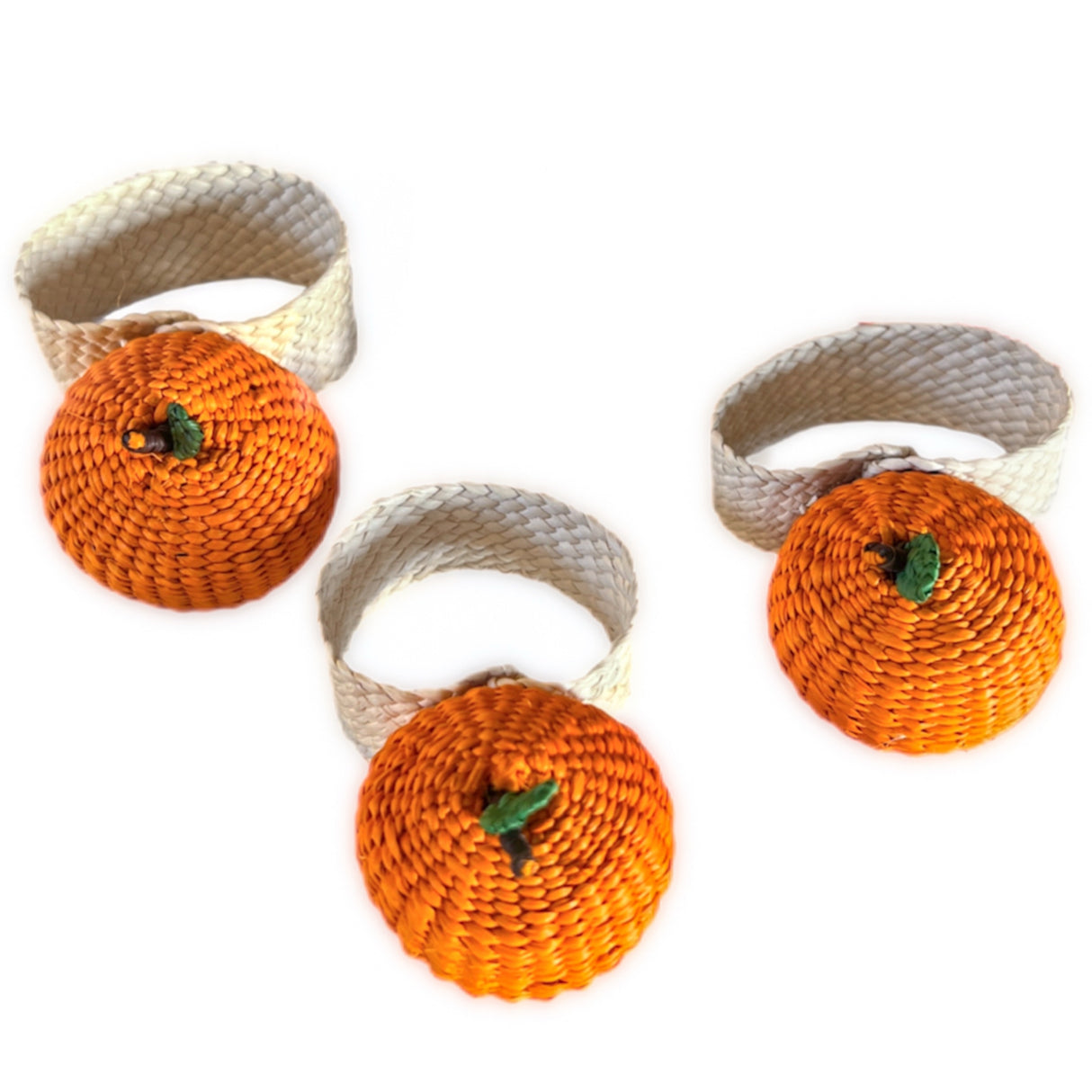 Set of three woven napkin rings shaped like pumpkins on a white background