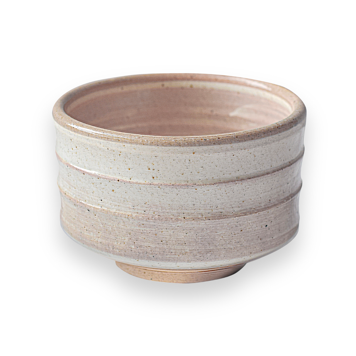 The Beige Ceramic Matcha Bowl features a textured design with subtle grooves and a wide brim, embodying traditional Japanese pottery. Its beige color against a black background enhances its elegance in simplicity, making it perfect for a matcha ritual.