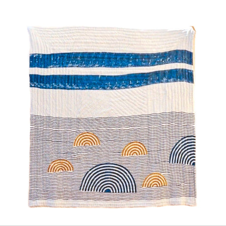 Quilt with blue, white, and multicolor patterns on a white background