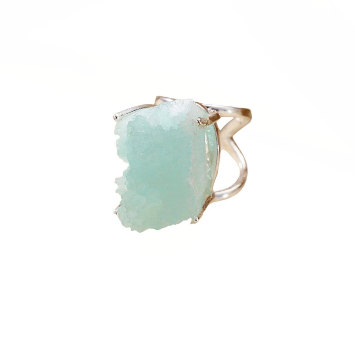 Silver ring with a large turquoise stone on a beige background