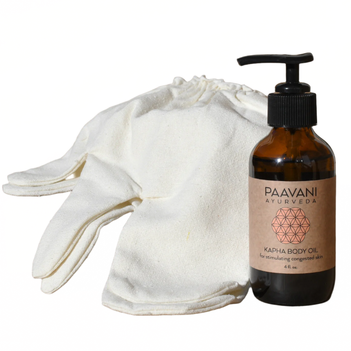 PAAVANI Ayurveda Kapha Body Oil bottle with a white cloth and gloves on a white background