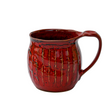 Red ceramic mug with a textured surface on a white background