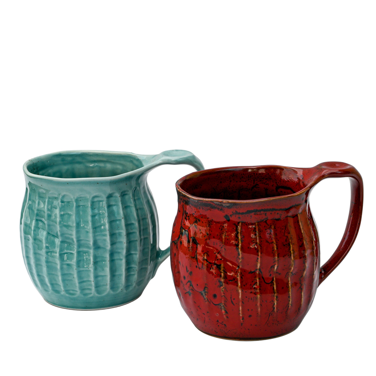 Two handmade Japanese ceramic mugs, one in vibrant red (18oz) and the other in teal, both feature an elegant ridged design. Set against a plain backdrop, these textured mugs make a striking display for tea or coffee enthusiasts.