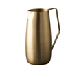 Gold pitcher with handle on a white background