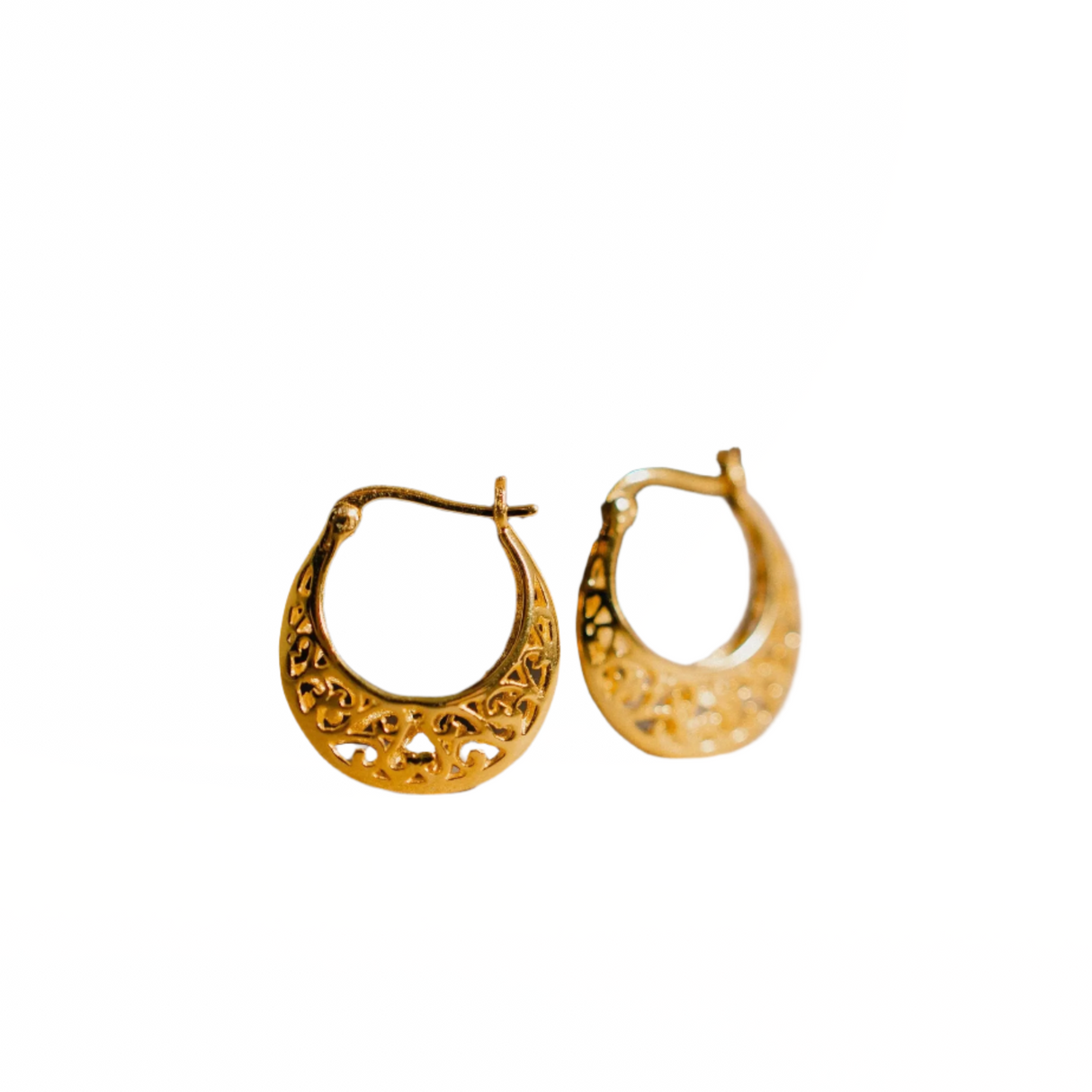 Pair of gold hoop earrings on a white background